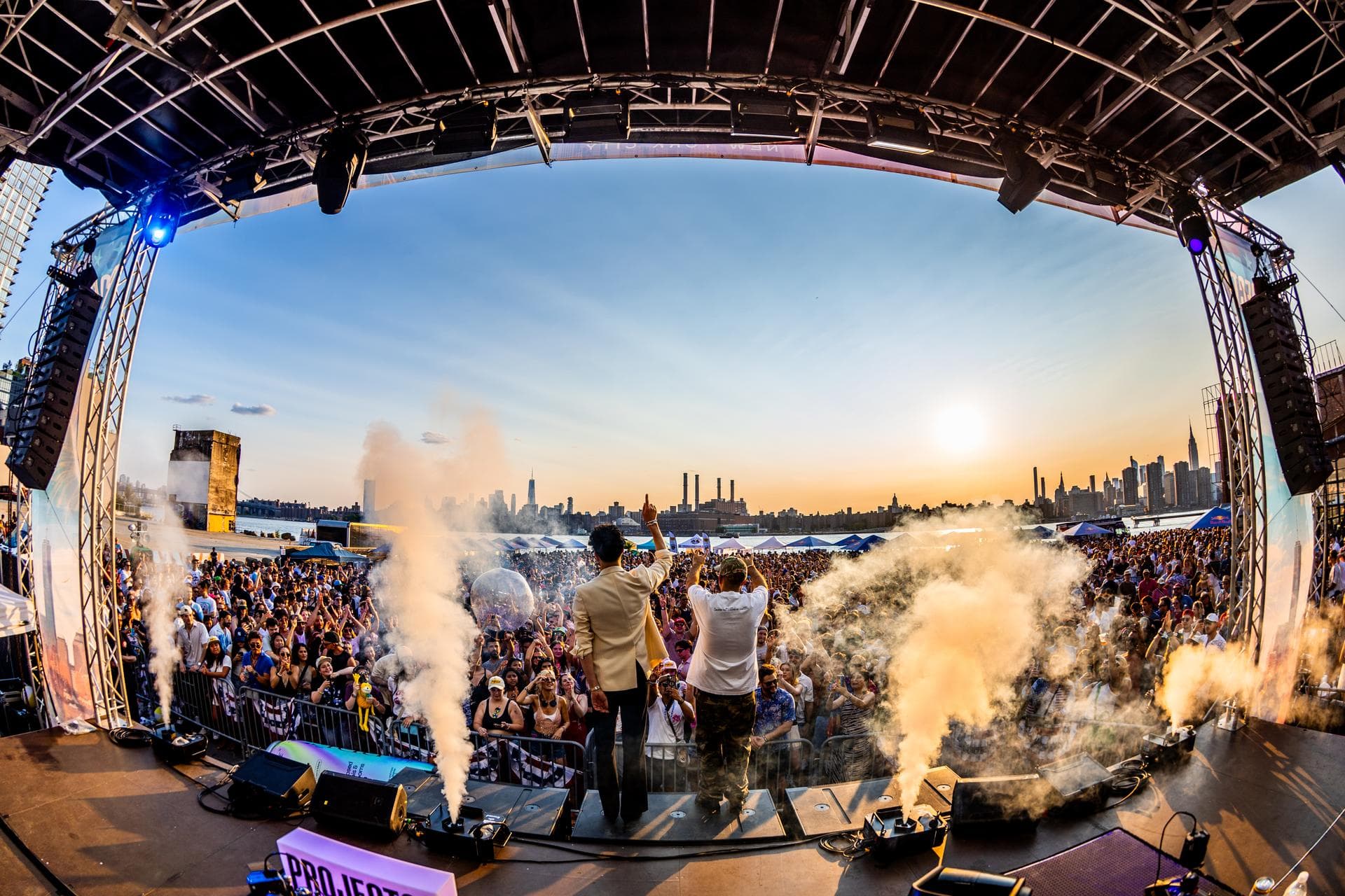 Performers on stage with CO2 jets firing into the crowd
