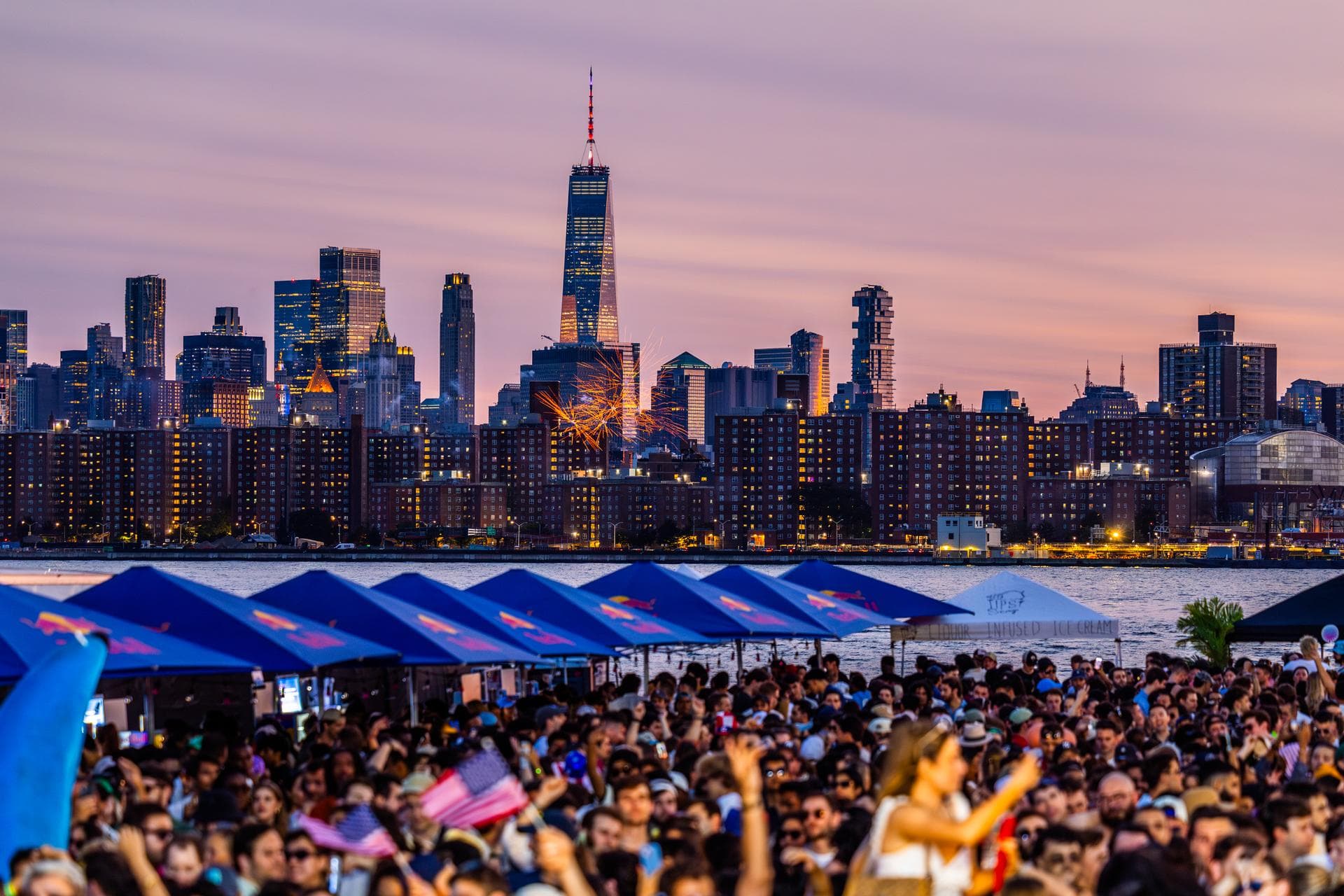 Fireworks over the Manhattan skyline above the crowd