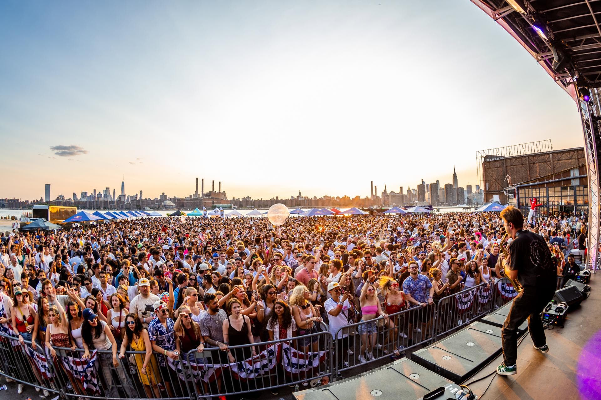 Wide stage view over the packed crowd with skyline