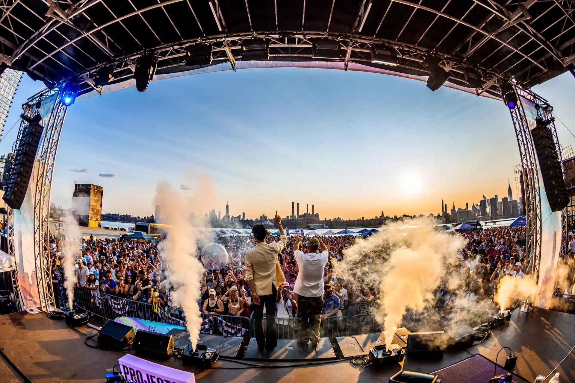 Performers on stage with CO2 jets firing into the crowd